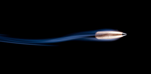 Flying copper jacketed bullet with blue smoke trailing behind on a black background. - obrazy, fototapety, plakaty