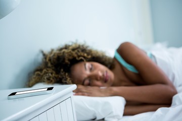 Young woman sleeping on bed 