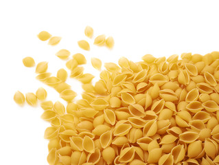Pile of dry conchiglie pasta over isolated white background