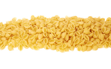 Line made of dry conchiglie pasta over isolated white background