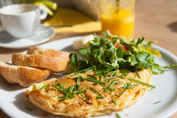 Herb omelette with chives and oregano sprinkled with chili flakes, garlic panini toasts