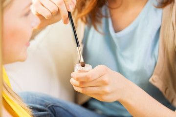 woman visagist applying eyeshade by makeup brush 