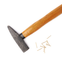 Big hammer with pile of nails over white isolated background