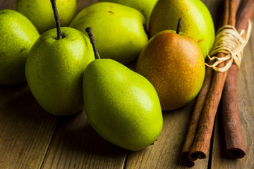 Fresh pears on a rustic wooden background