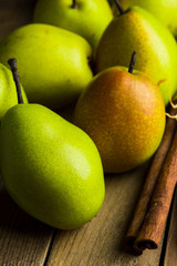 Fresh pears on a rustic wooden background