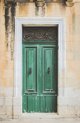 Green Wooden Doors with Black Metal Knockers