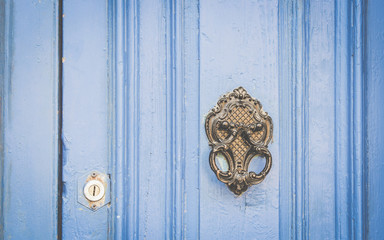 Old Metal Knocker on Blue Wooden door