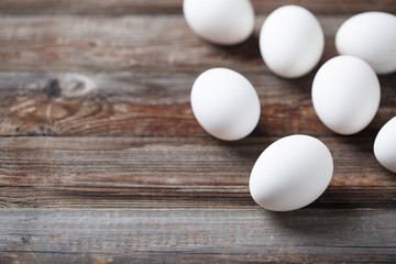 White eggs on a rustic wooden table
