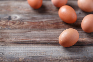 Brown eggs on a rustic wooden table