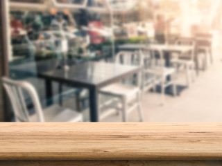 wooden counter top with empty restaurant blurred background