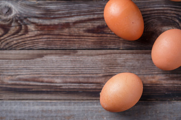 Brown eggs on a rustic wooden table