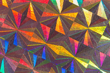 Psychedelic abstract formed by light reflecting off a textured metal surface