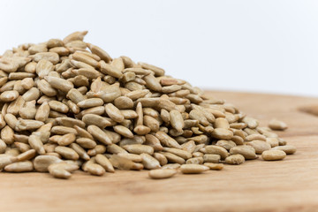 Pile of sunflower seeds on the wooden board