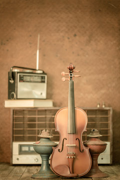 violin and old radio in vintage style on steel background