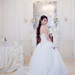 Fototapeta premium Portrait of beautiful bride. Wedding decoration. Luxurious light interior