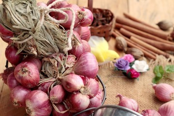 raw shallots for cooking on wood background.