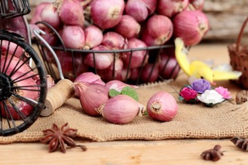 raw shallots for cooking on wood background.
