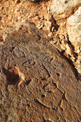Prehistoric engraved stone face imitation