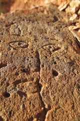 Prehistoric engraved stone face imitation