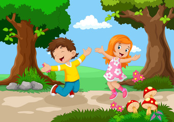 Obraz na płótnie Canvas Boys and girls jumping for joy in a beautiful garden