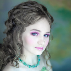 Fototapeta premium Little girl with beautiful makeup. Little girl in a vintage dress. portrait of a little princess