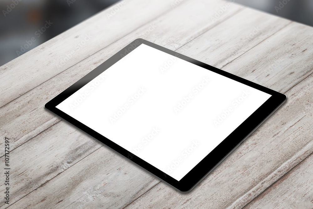 Poster Black tablet on wooden table with isolated white screen for mockup. Horizontal position isometric view.