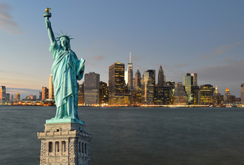 Manhattah skyline at night and Statue of Liberty.
