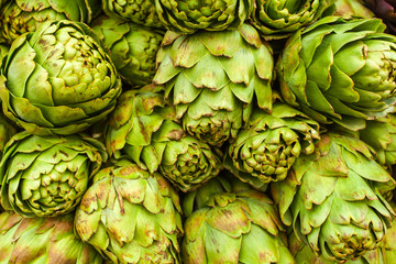 Roman artichokes at farmers market. Background.