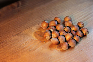 Filtered image of Hazelnuts in a wooden bowl on rustic background