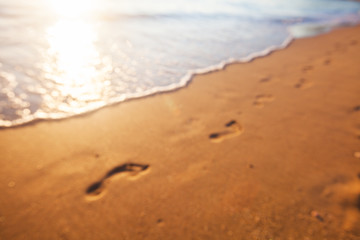 Fototapeta na wymiar Blurred background of footprints at sunset time