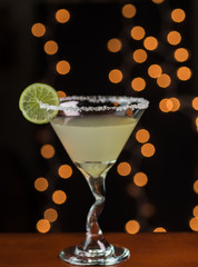 Classic margarita cocktail garnished with salt rim and lime wheel.