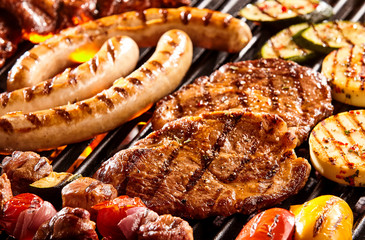 Various meats and vegetables on hot grill - obrazy, fototapety, plakaty