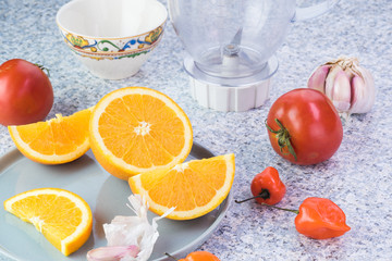 Ingredients for chili sauce. Orange, tomatoes, garlic, chili pep