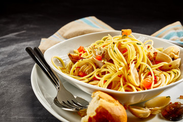 Spaghetti Pasta with Clams Served with Bread Roll