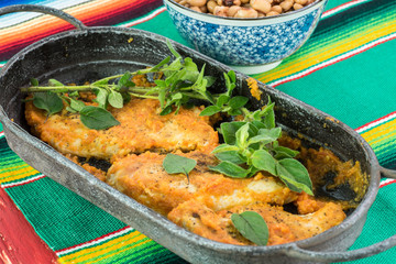 Fresh cooked chicken breast with chili sauce in a skillet.