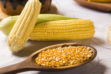 close view on Homemade golden corn cob with butter and salt on t