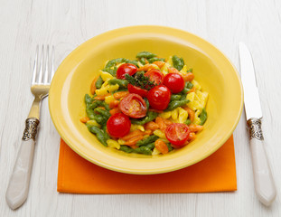 colored spatzle on yellow dish