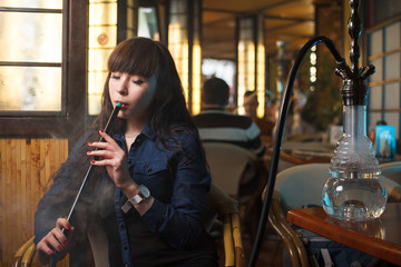 Beautiful young woman with hookah