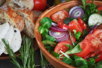 Fresh vegetable salad with tomatoes, cucumbers and onions. Serve