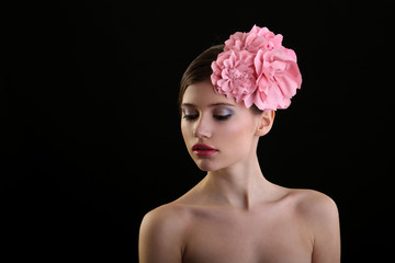 beautiful young girl with pink flowers on her head