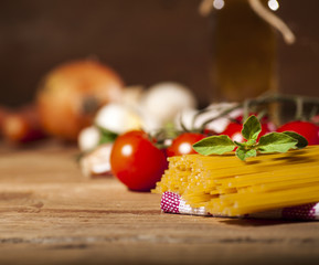 Pasta ingredients on wooden background