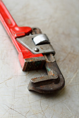 red screw-wrench on a metal background