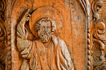 God sculpture in wood on a Christian door church