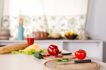 kitchen background with vegetables, knife and boards