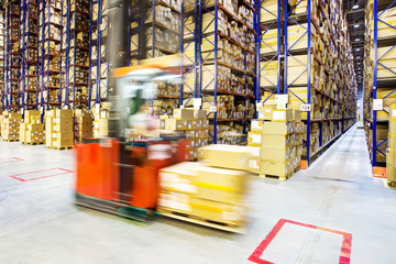 Large modern warehouse with forklifts