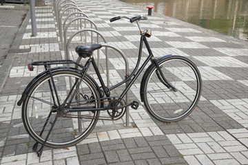 Naklejka na ściany i meble Bike Parked next to Canal, Rotterdam