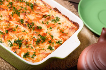 Dish with the baked potatoes on a kitchen table