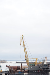 Fototapeta na wymiar Cheboksary, Russia - April 2, 2016: floating crane in the river port in winter