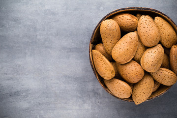Group of almond nuts with leaves.Wooden background.
