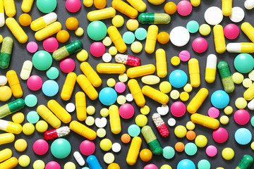 Colorful pills on grey background